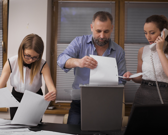 office workers shredding documents