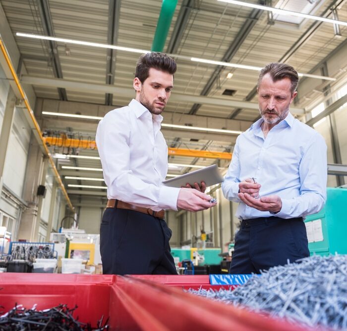 two men in a factory