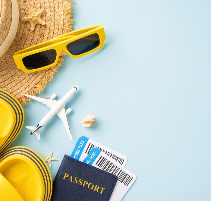 hat, sandals, model airplane and passport