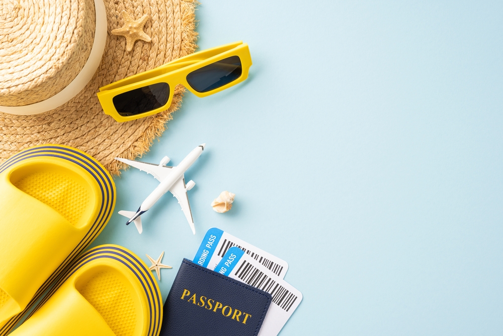 hat, sandals, model airplane and passport