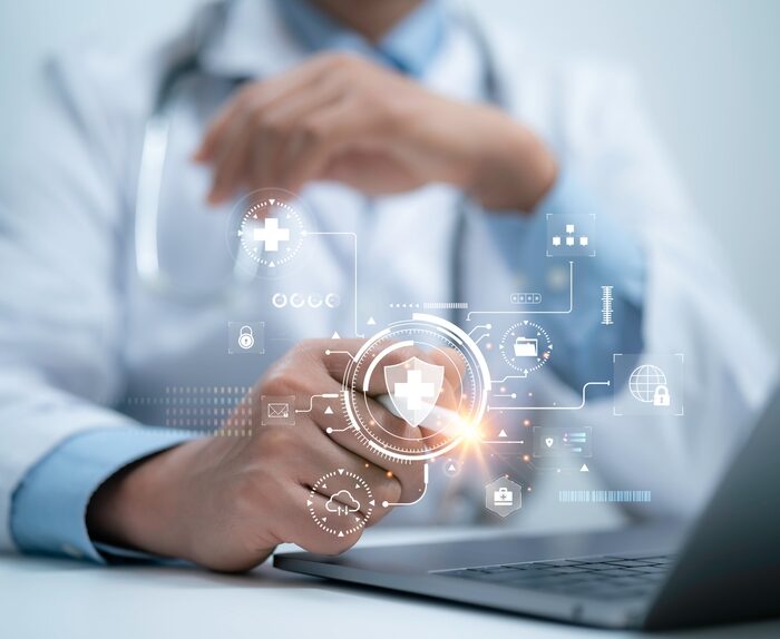 medical data graphic over a doctors laptop