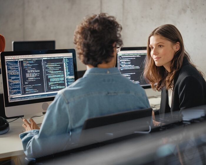 two people using desktop computers