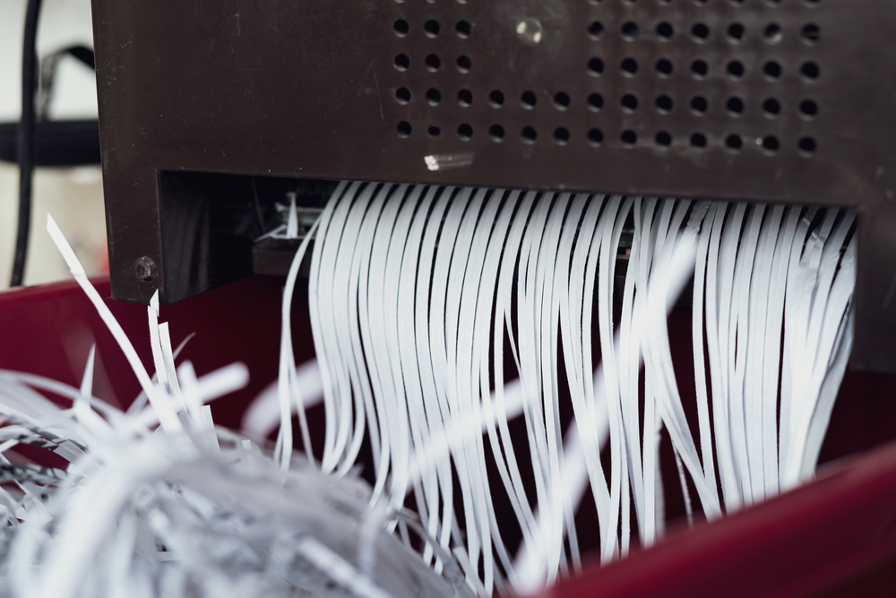 shredded paper coming out of a machine