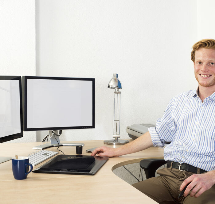 man sitting at a clean desk