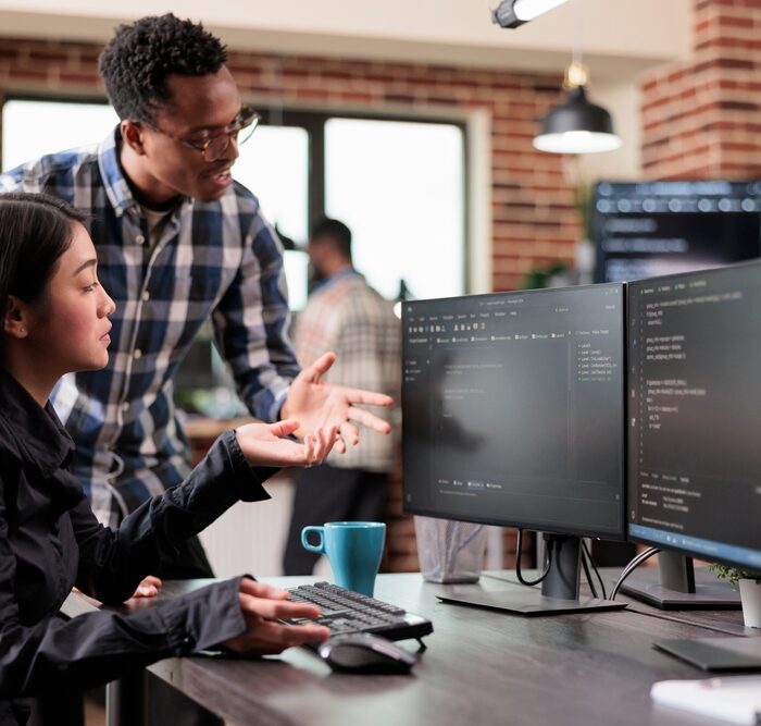 two people looking at a computer monitor