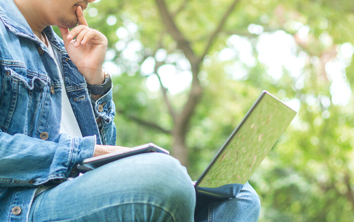 person using a laptop outdoors