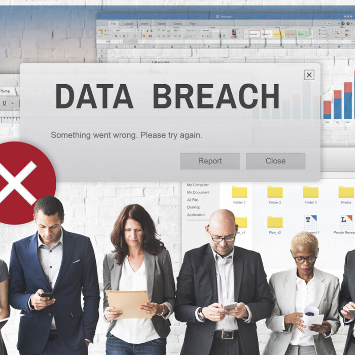 Data Breach graphic above people looking at documents and devices