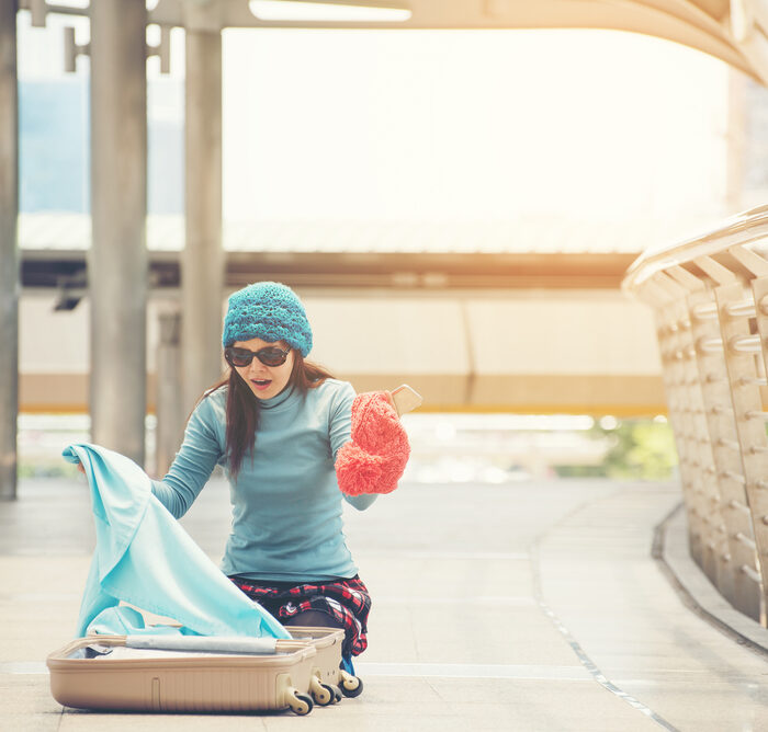 woman looking through her luggage