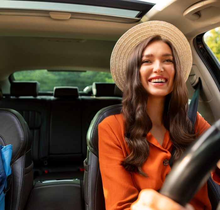 woman driving with the sunroof open