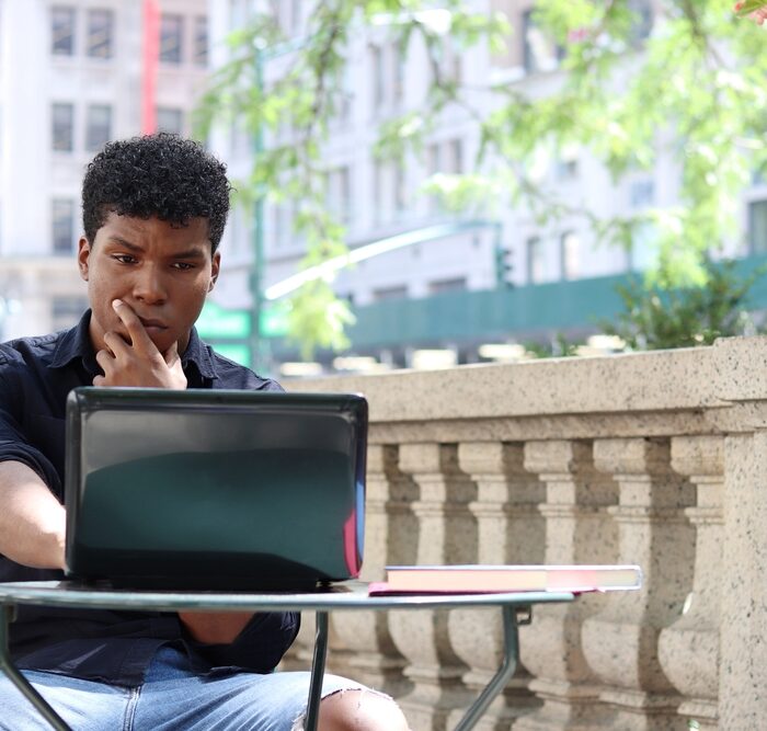 man using a laptop outdoors