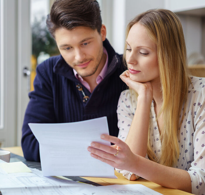 man and woman reviewing paper documents