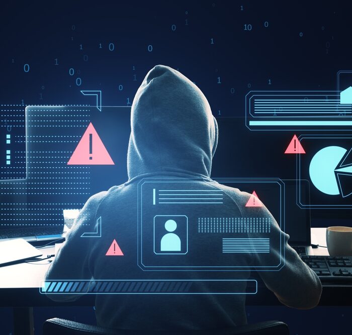 graphic of identity theft in front of a hooded man