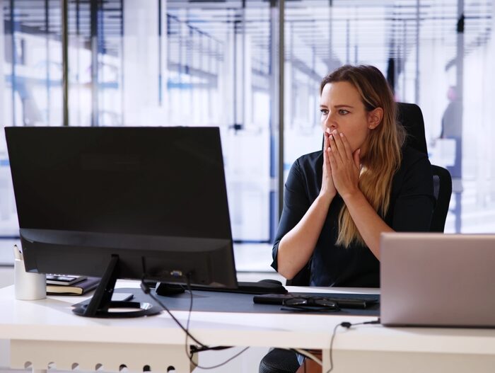 concerned woman looking at a computer screen