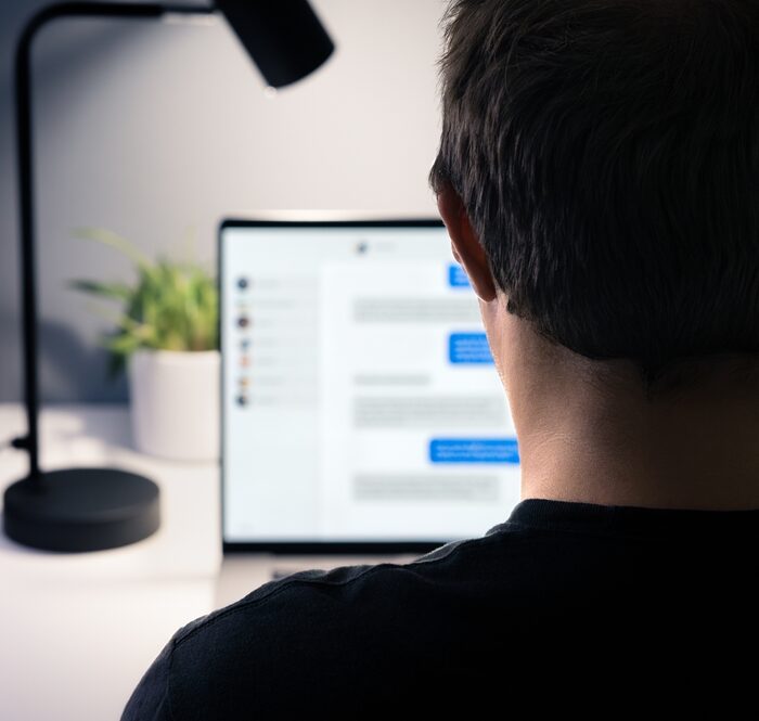 person viewing text messages on a laptop screen