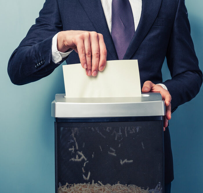 man shredding documents