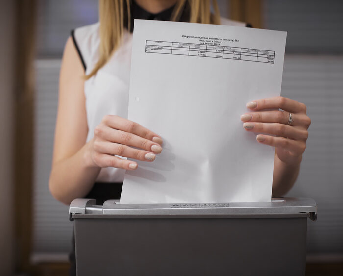 woman shredding paper document