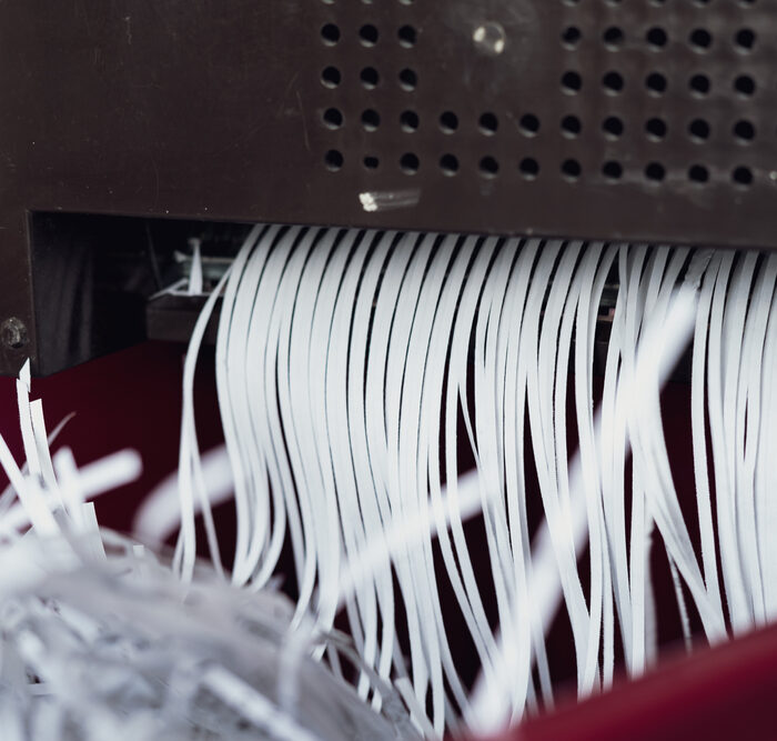 shredded paper exiting a shredder