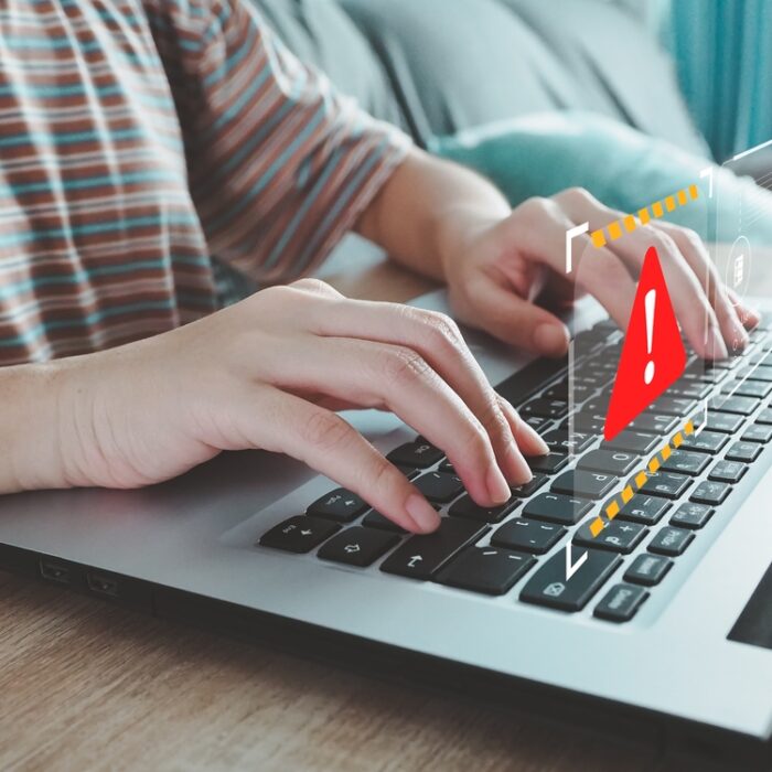 fraud alert graphic over a laptop