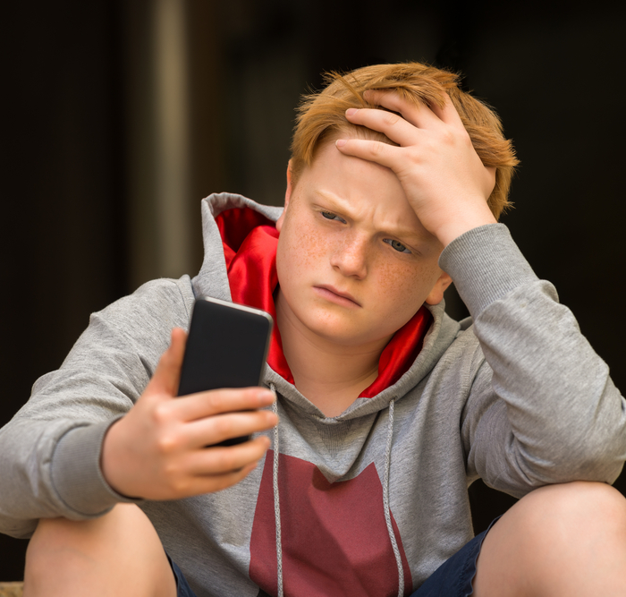 child looking at a smartphone