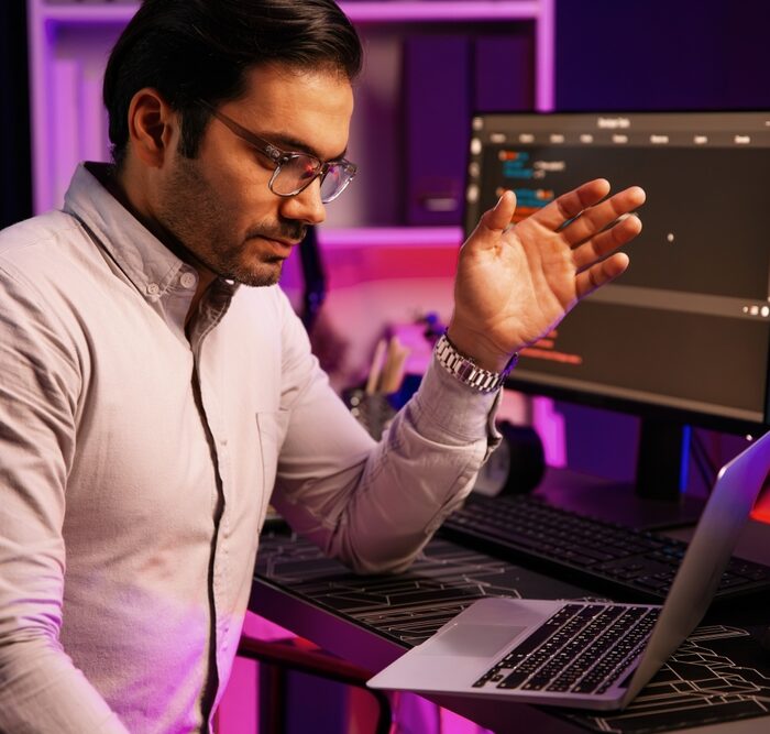 concerned man looking at a laptop computer