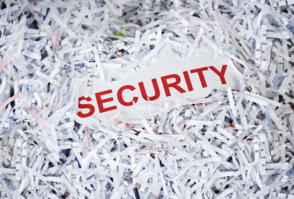 the text "security" in a pile of shredded paper